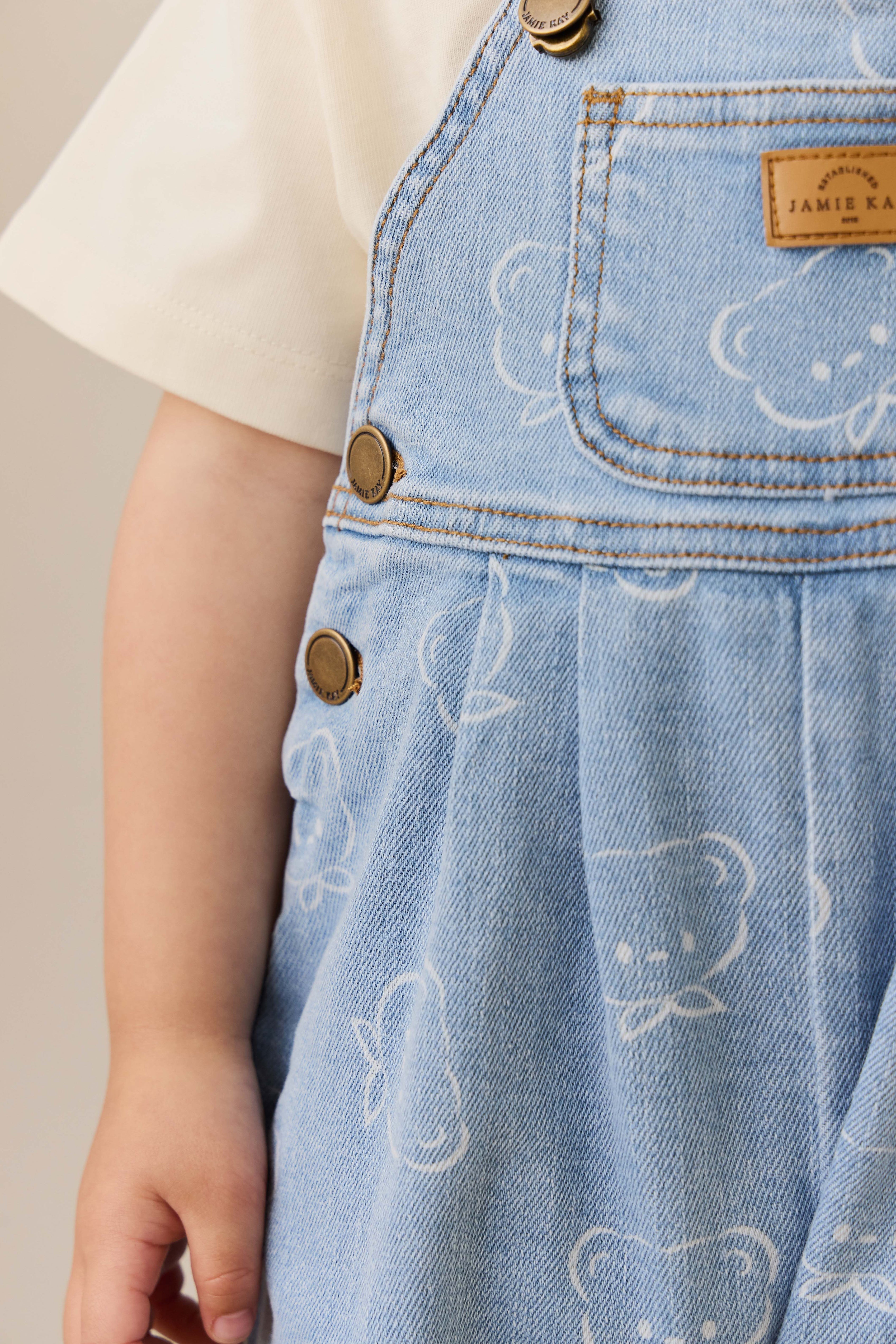Salopette en jean bleu clair décontractée en coton imprimé Bowie avec bretelles réglables et poche bavette pour enfants de 6 mois à 6 ans